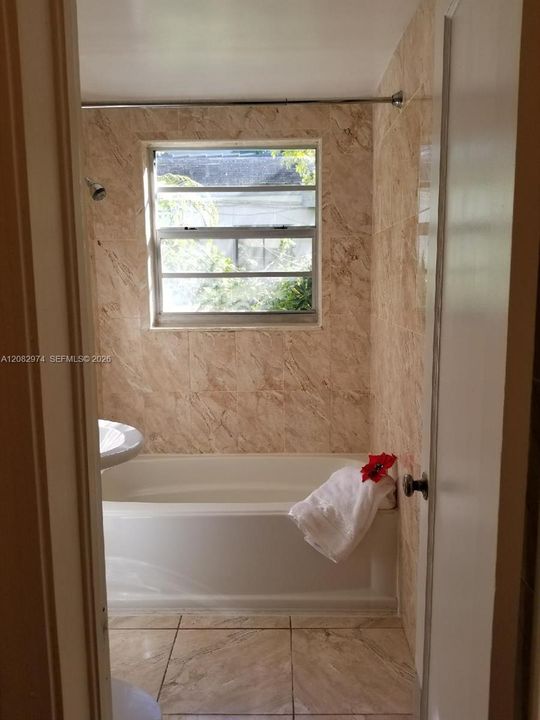 AI-modified image. Shower curtain digitally removed