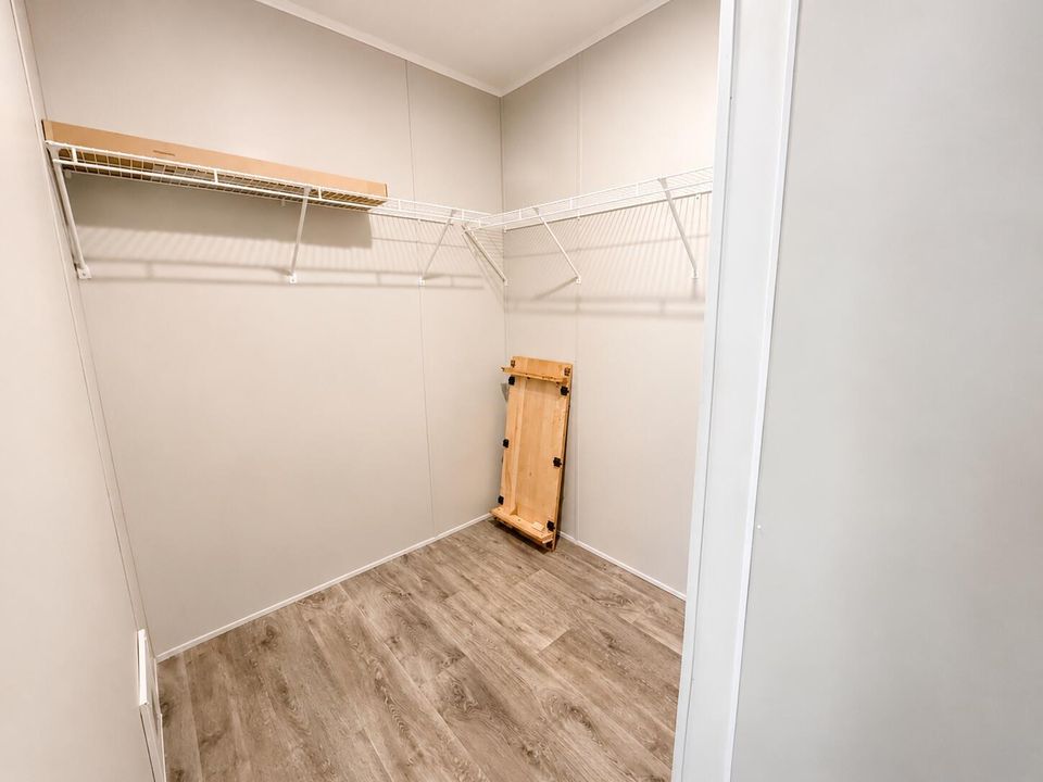 Bright Empty Walk-In Closet with Wire Sh