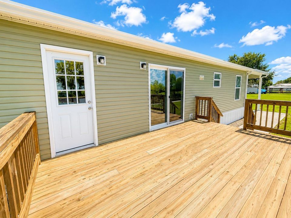 Sunny Wooden Deck and Sage Green House