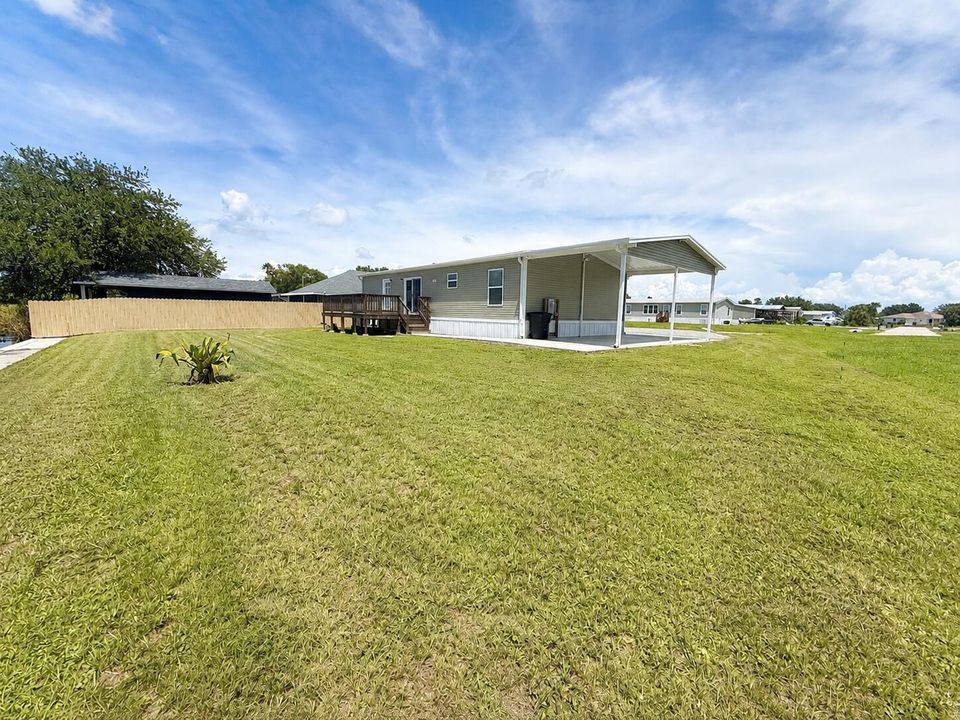 Sunny Backyard with Manufactured Home an