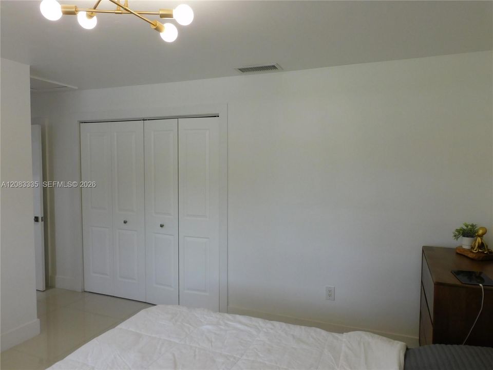 Primary Bedroom with Side by Side by Side Closet.