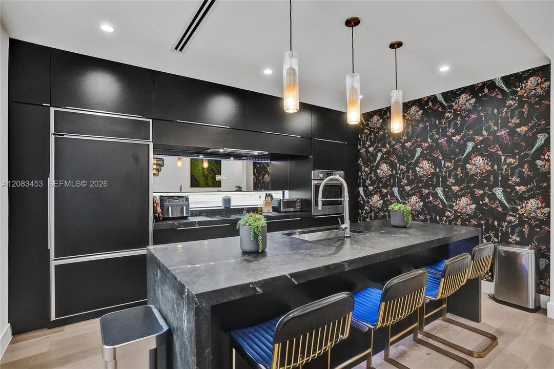 Chefs kitchen with huge center island and high-end appliances