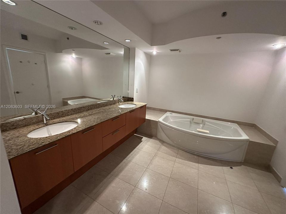 The primary bathroom has dual sinks and a whirlpool tub.