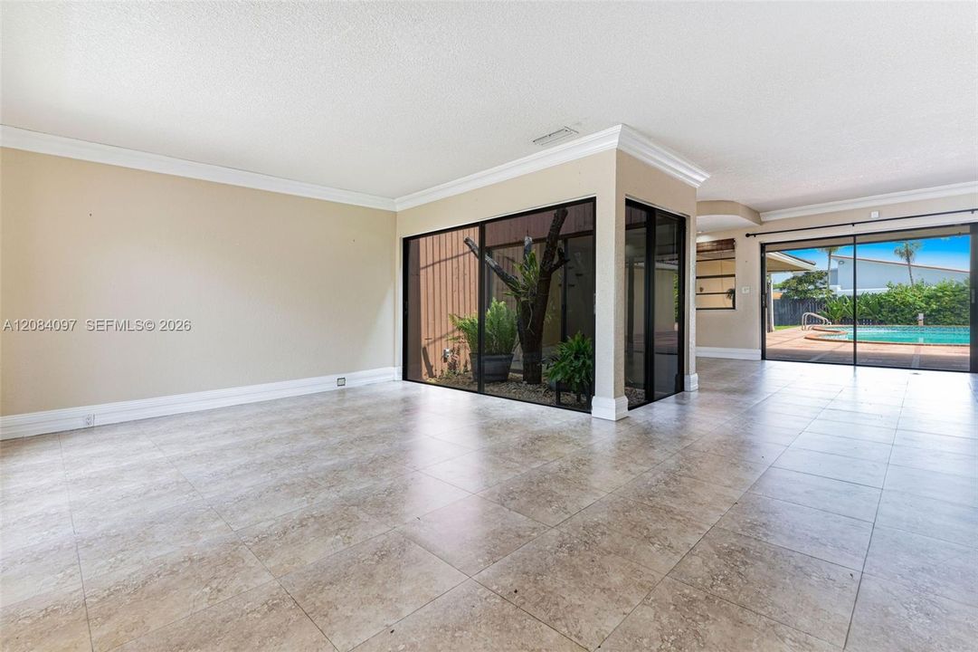 Living room overlooks interior garden and pool area