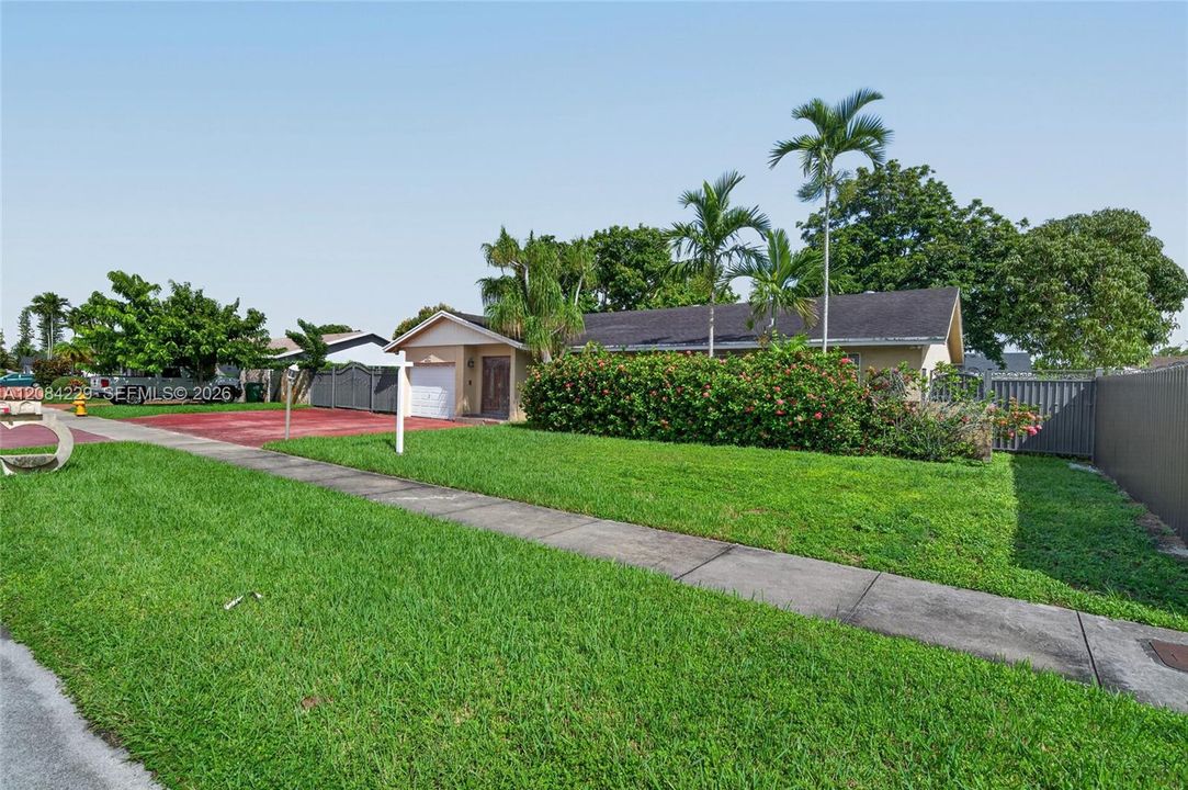 Spacious driveway with a metal gate