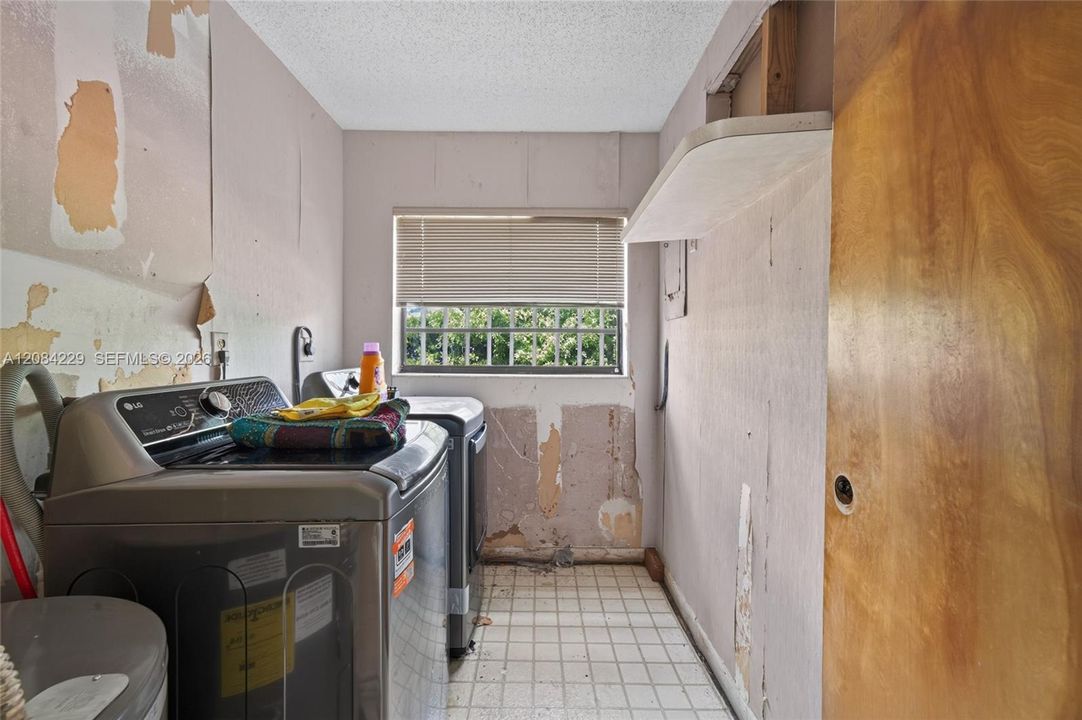 Laundry room with newer washer and dryer