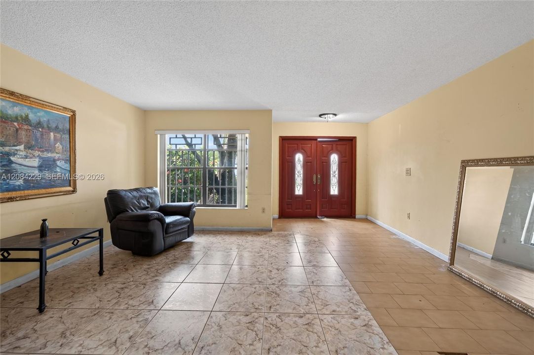 View to the double front door from the living area