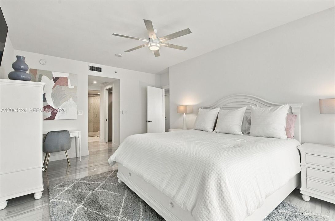 Fully furnished primary suite with a king-size bed.