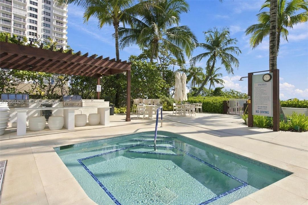Relaxing outdoor spa surrounded by beautifully maintained tropical landscaping.