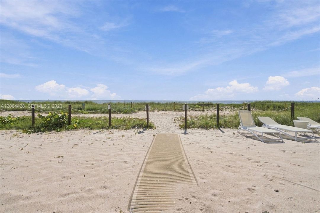 Private beachfront lounging area with direct access to the wide sand and Atlantic Ocean.