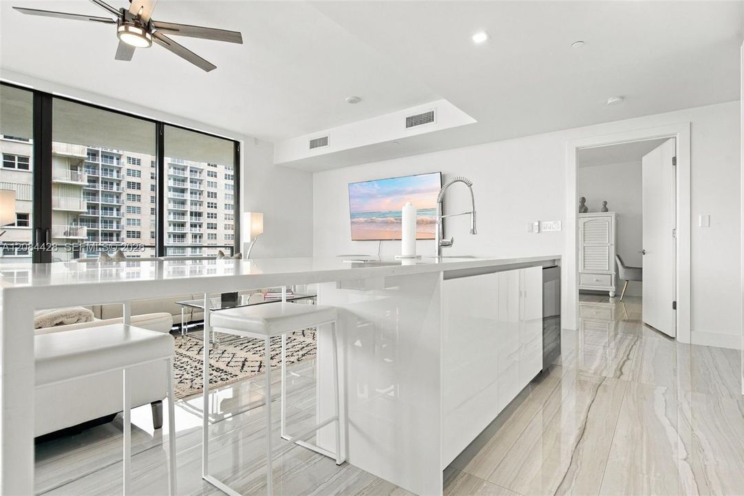 Oversized kitchen island with seating and generous preparation space.