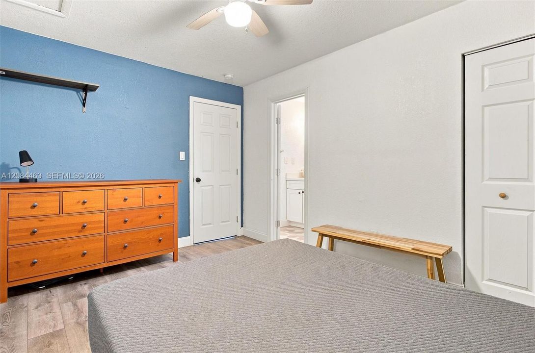 Spacious bedroom with large closet and the added convenience of a full-size washer and dryer located just steps away
