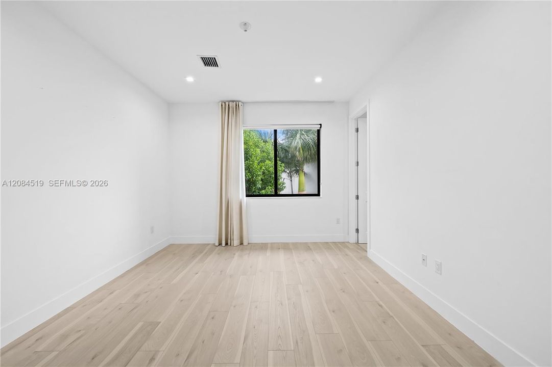 MASTER BEDROOM WITH A VIEW OF THE GARDEN