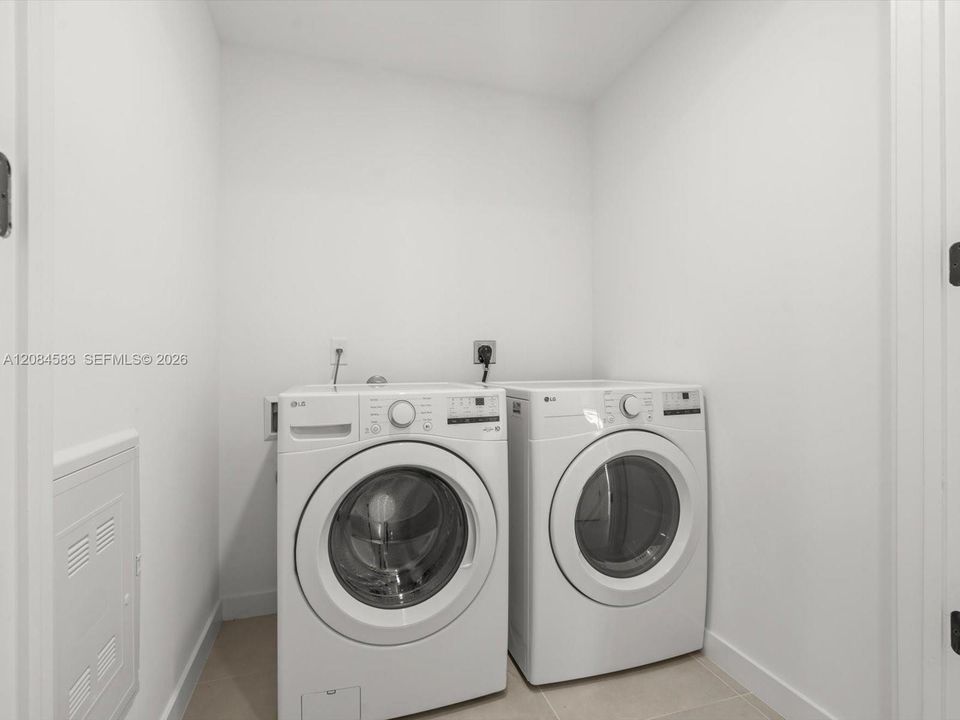 Dedicated laundry room with full-size washer and dryer
