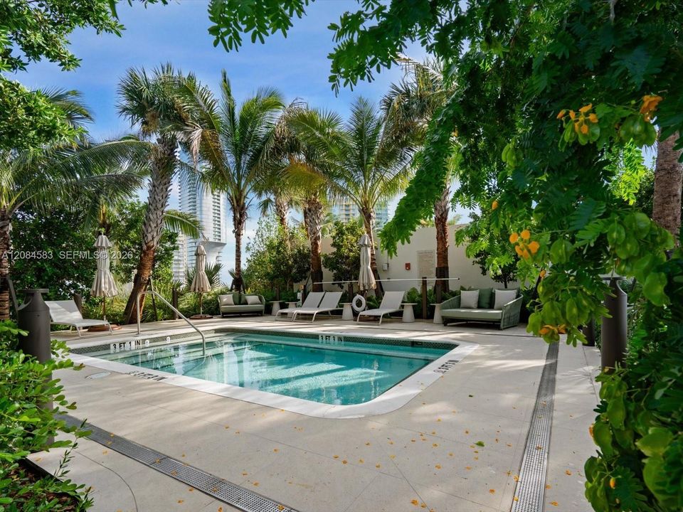 Resort-style rooftop spa with lush tropical landscaping
