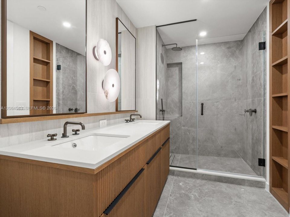 Primary bathroom with dual vanity and glass-enclosed shower