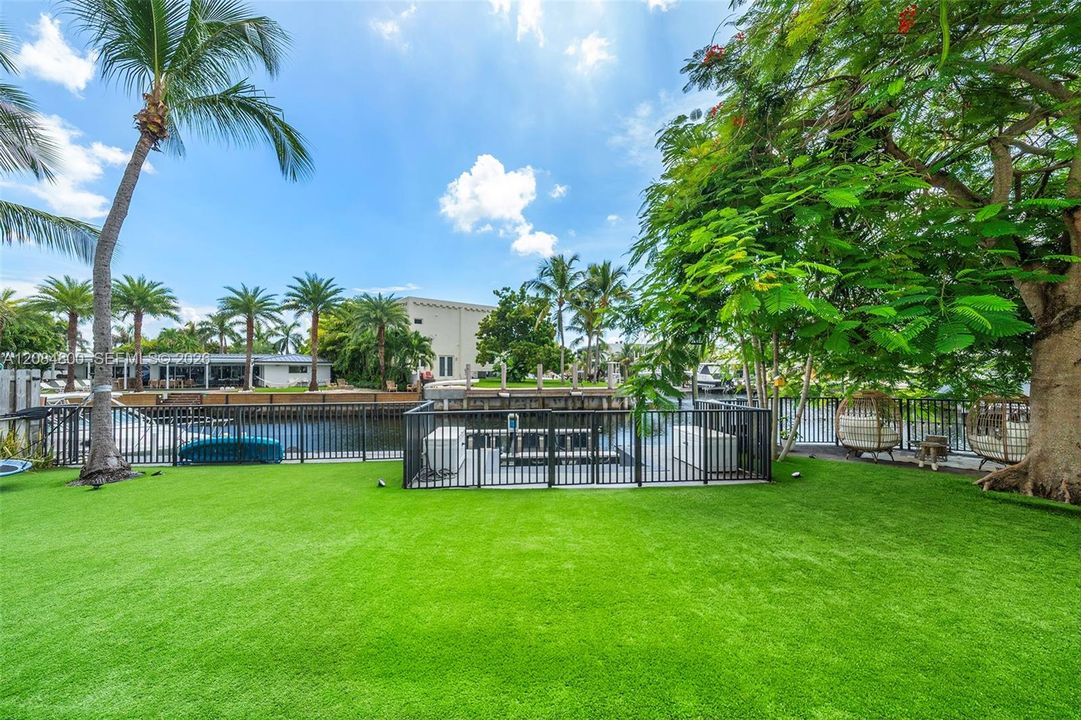 Pool is surrounded by lush gardens