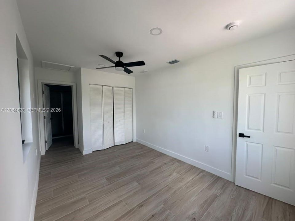 Master bedroom with attached bathroom and closet