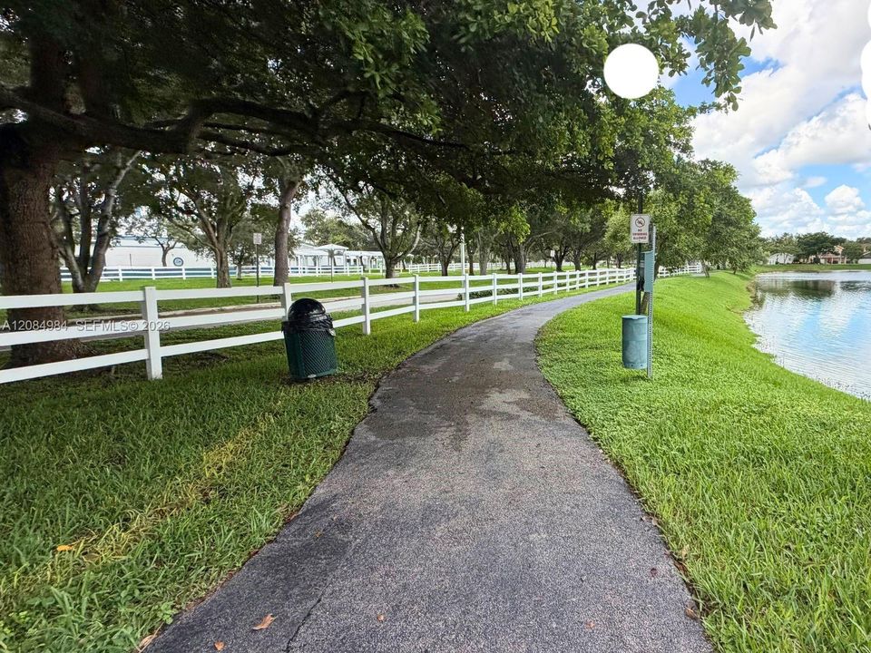 (Community / Walkway): Serene walking paths along lush landscaping and scenic water views.