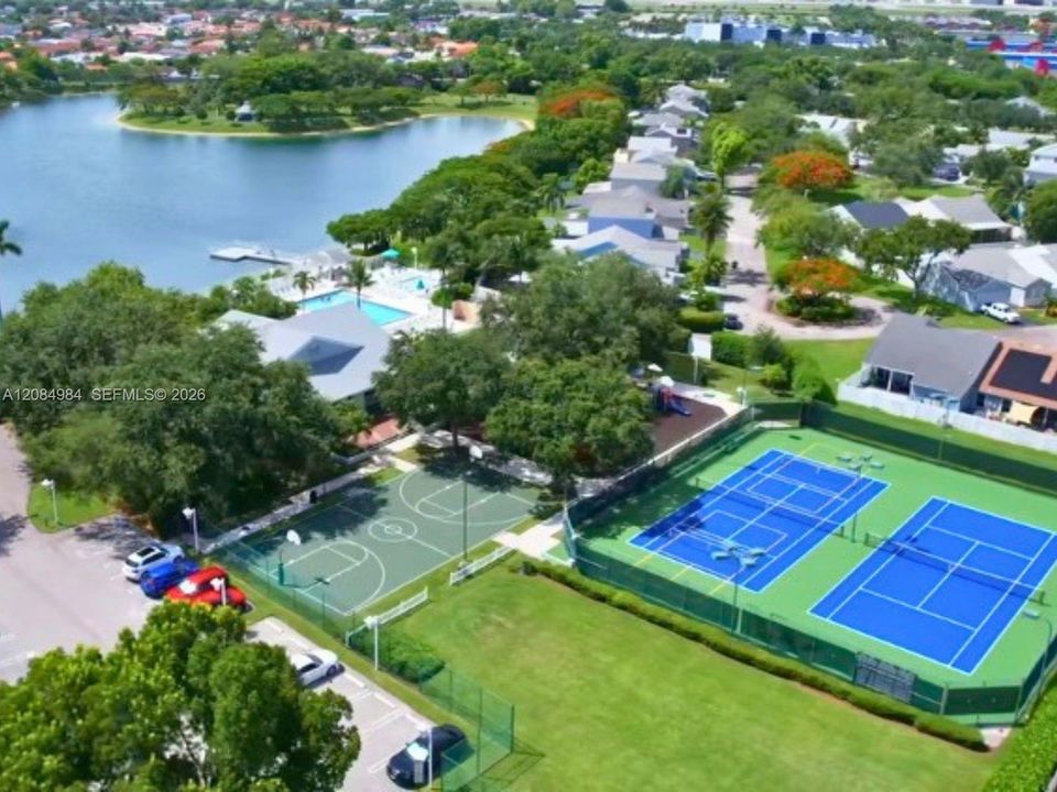 Aerial overview of community amenities including pool, tennis courts, and green spaces.