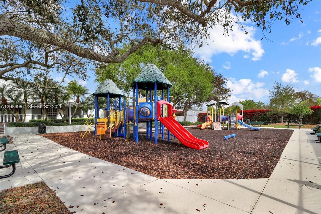 Outdoor playground area set in a shaded community environment.
