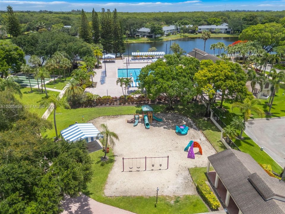 Aerial view highlighting the community’s lush grounds, recreational amenities, and waterfront setting.