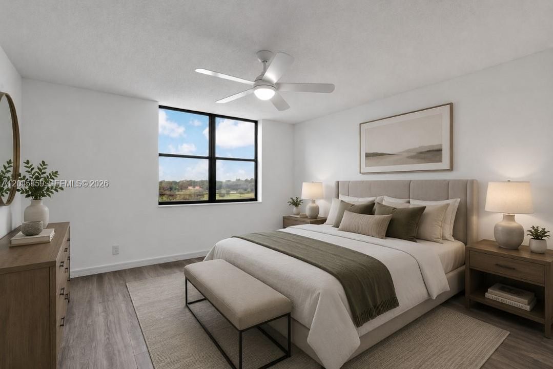 Generously sized primary bedroom featuring large windows framing serene water views. Virtually staged.