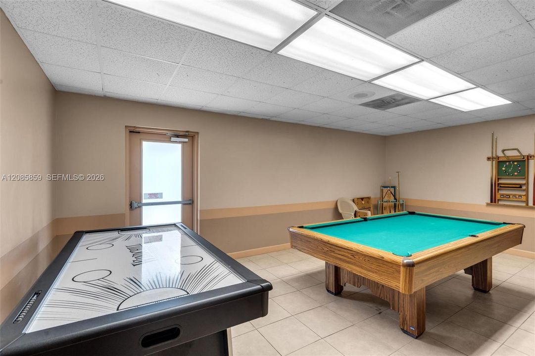 Additional clubhouse recreational amenities including air hockey and pool tables for everyday enjoyment.