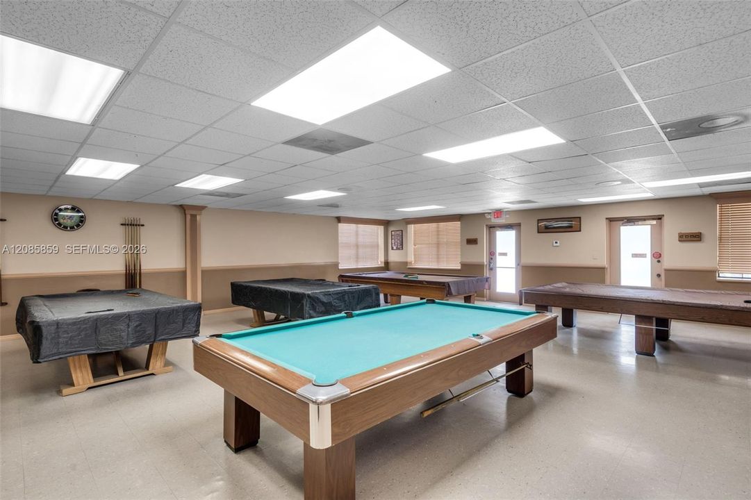 Resident game room featuring multiple pool tables and a spacious entertainment area.