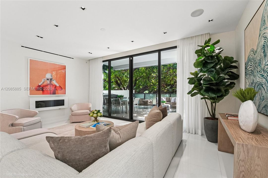 Floor to ceiling glass windows opens the space directly onto a private terrace