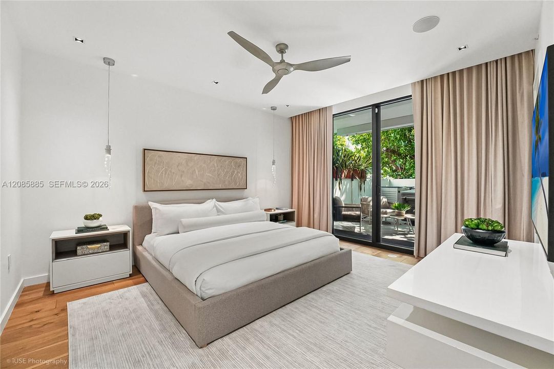 The oversized primary bedroom is a private retreat in its own right, offering direct access to the terrace