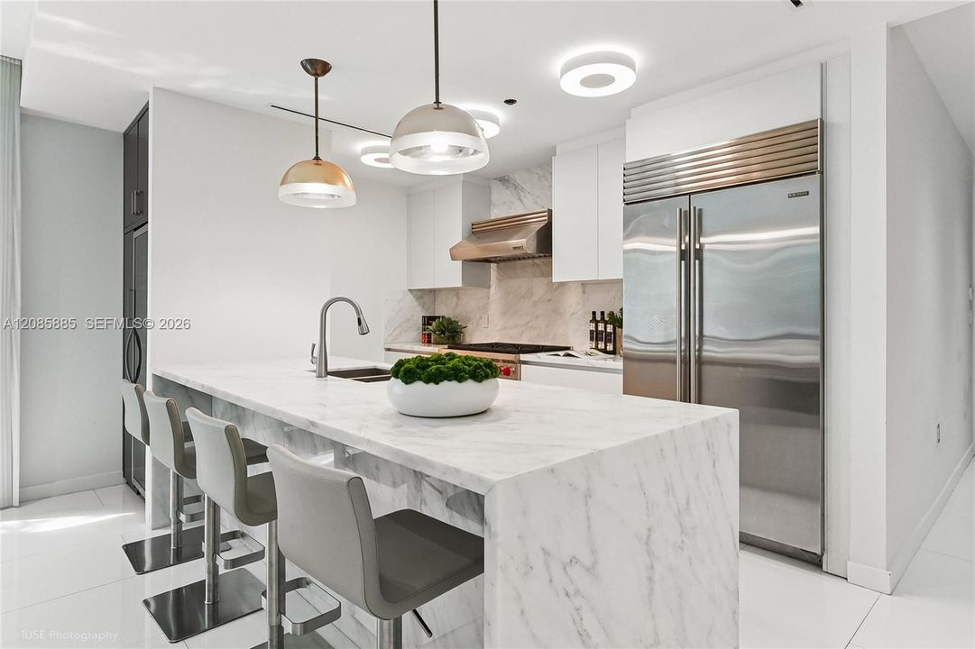 The space flows seamlessly into the living and dining areas, creating one continuous, light-filled gathering space rather than a closed-off room