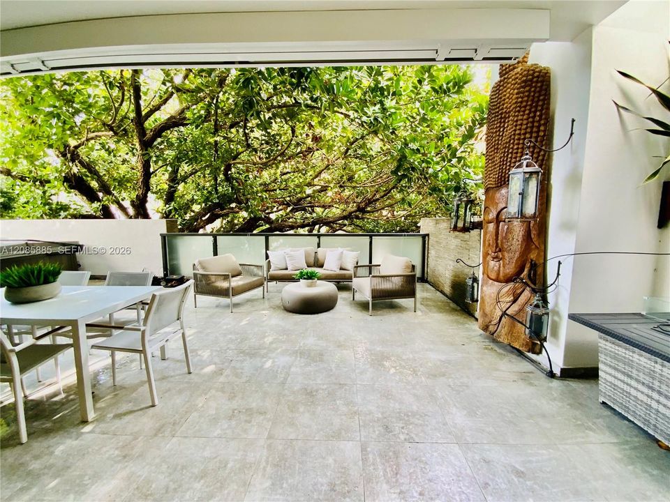 Private covered terrace - banyan tree canopy views. Indoor-outdoor ease.
