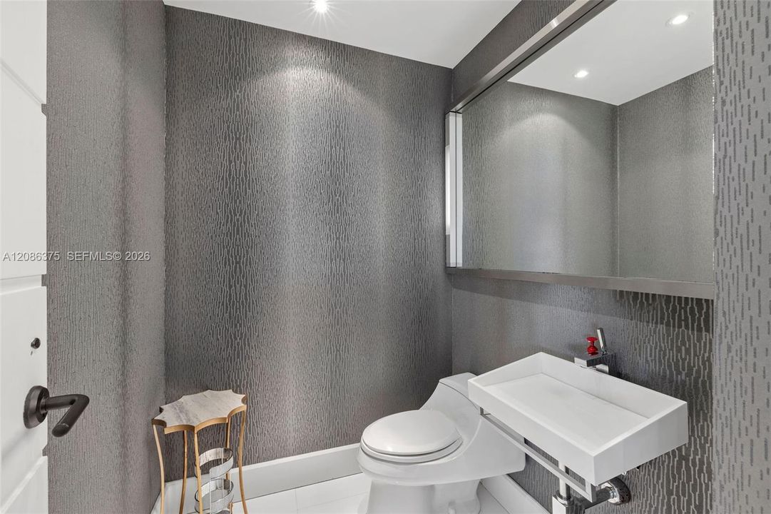 Guest half bath in foyer