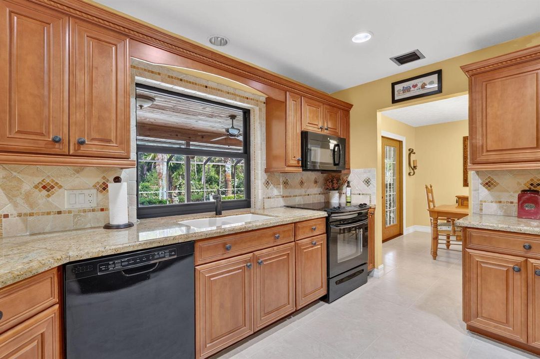 Kitchen w/window overlooking pool.