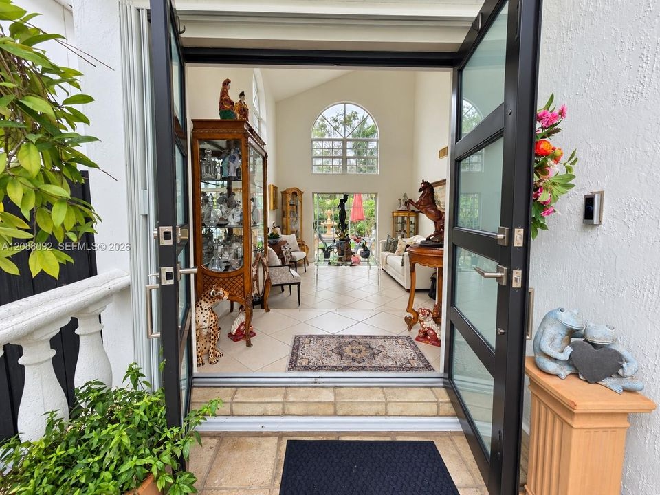 Double impact doors into foyer followed by Living Room