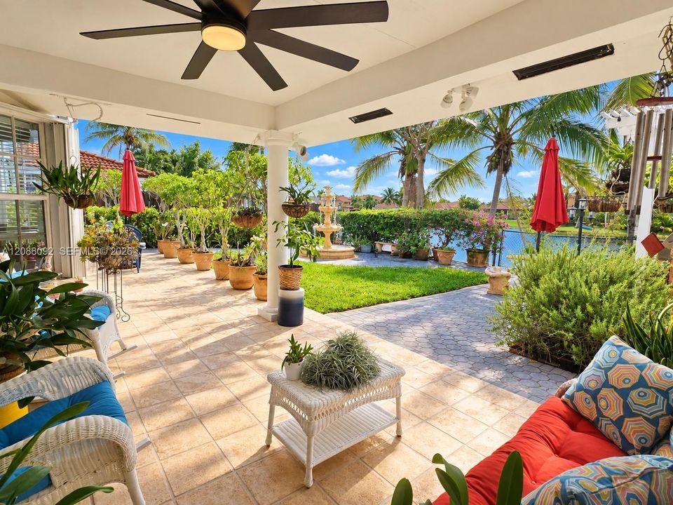 The gentle sound of the fountain, lush tropical landscaping and tranquil lake views make this backyard a peaceful retreat.