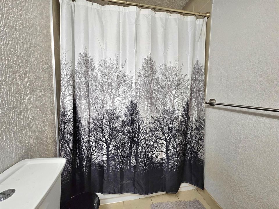 SHOWER IS TILED UP TO THE CEILING