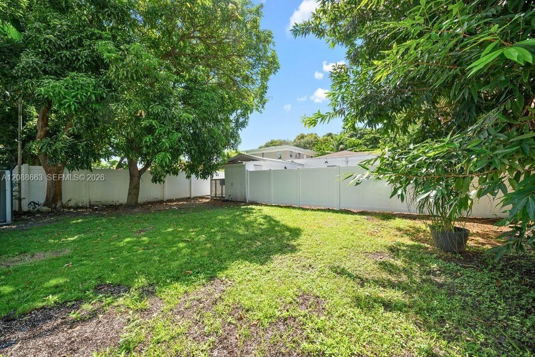 Private, fully fenced backyard offering an exclusive green outdoor retreat for weekend relaxation.
