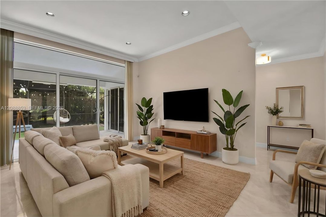 Virtual staging. Full impact doors opening to serene patio views