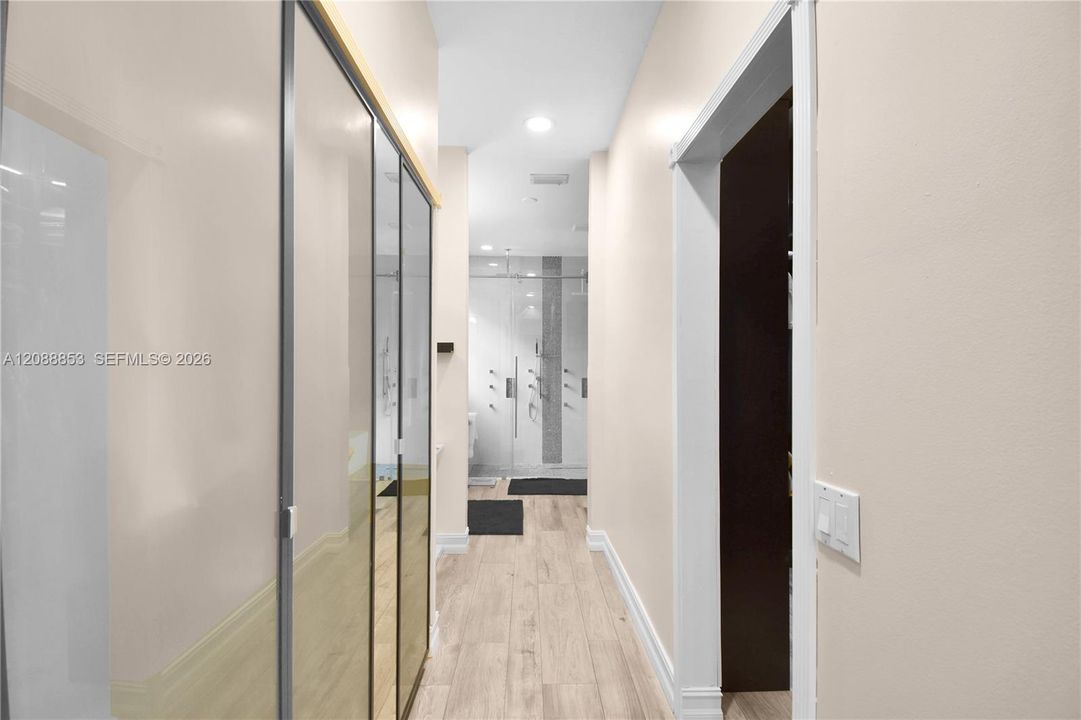 Custom His & Hers closets, a makeup vanity area leading to the primary bathroom