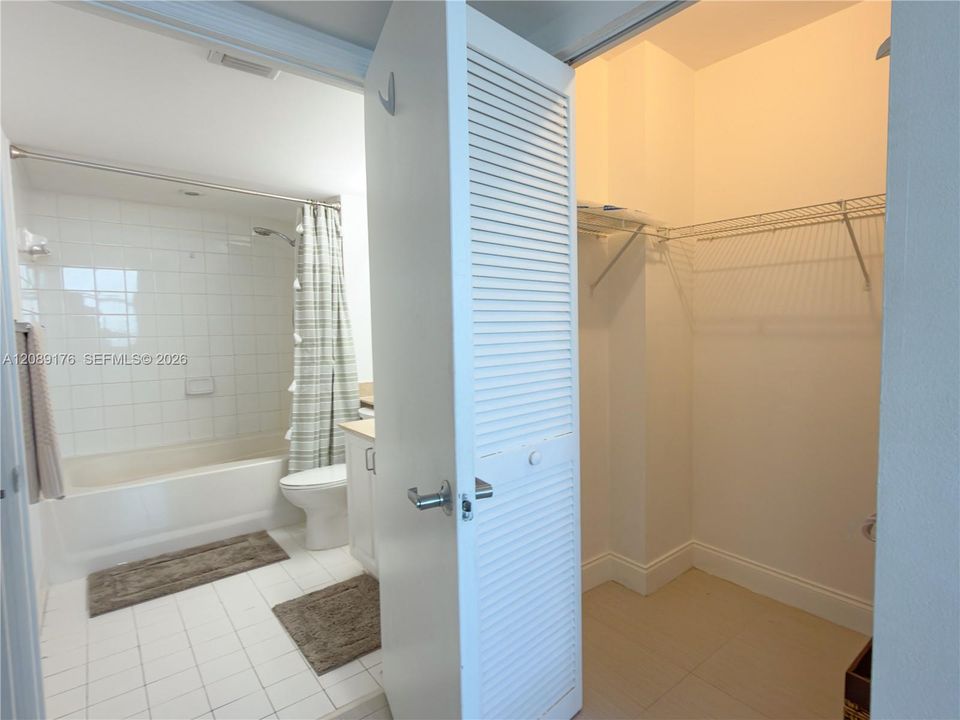 Primary bathroom featuring a walk-in closet