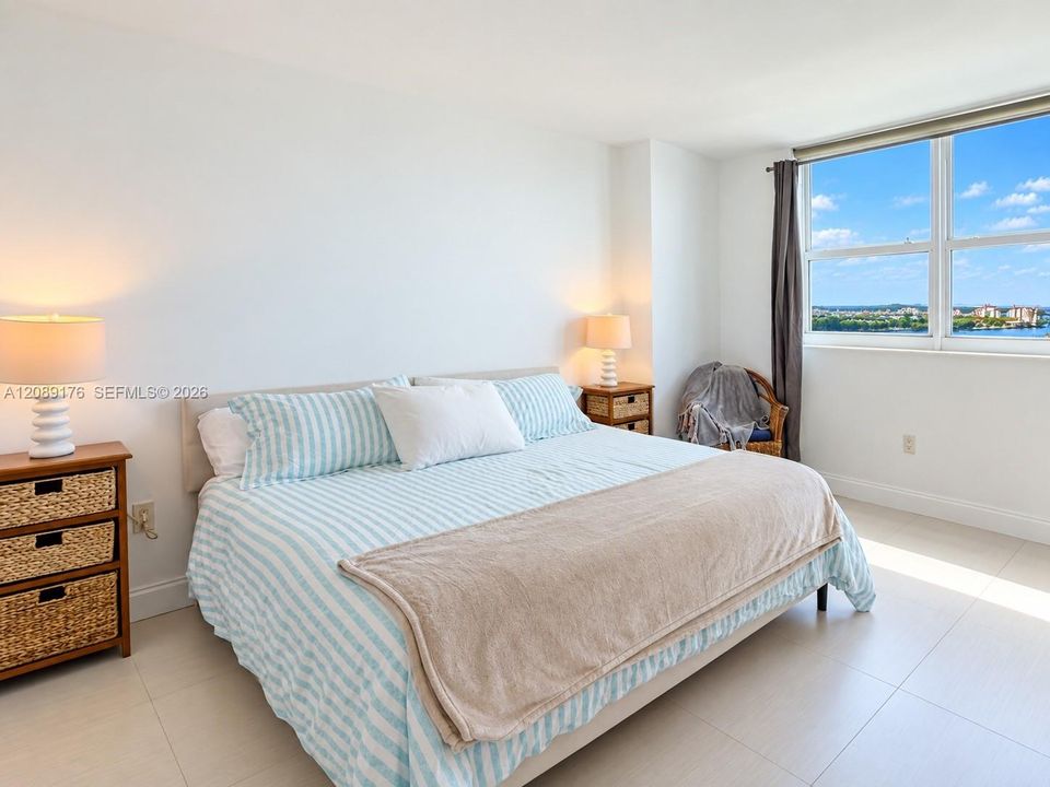 Primary bedroom filled with natural light and expansive outdoor views