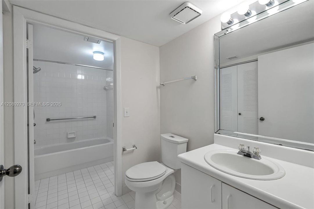 HALF BATH LEADING TO TUB/SHOWER
