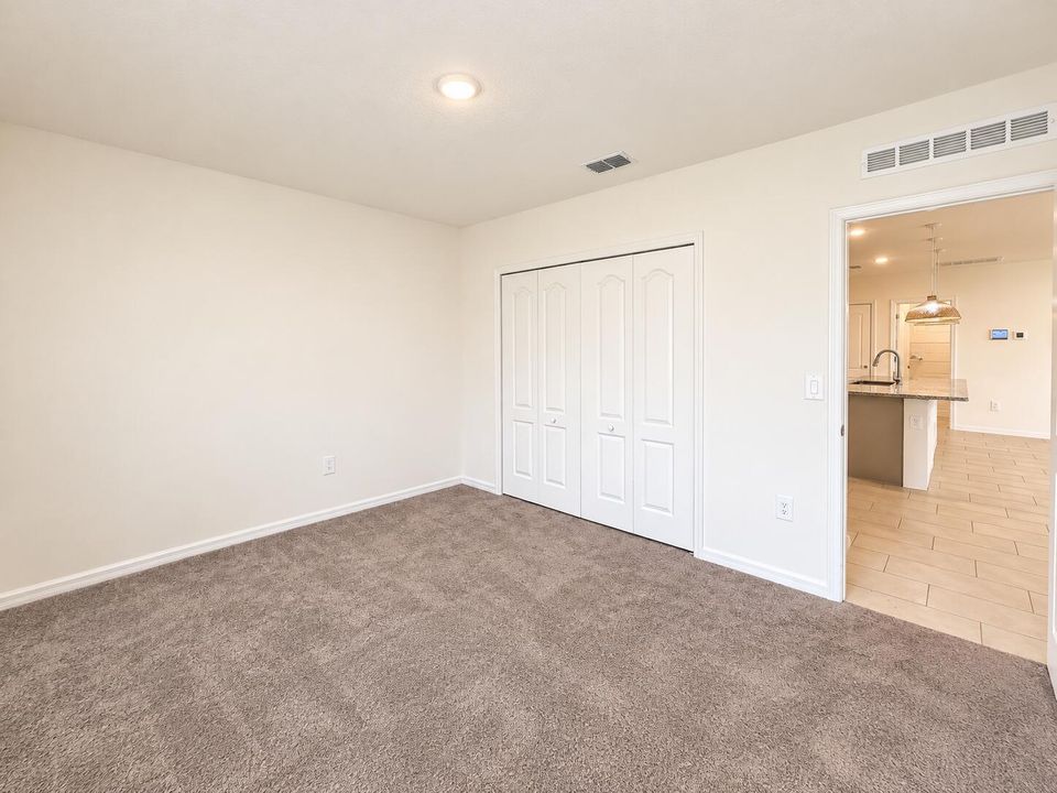 Bright Empty Bedroom with Kitchen View