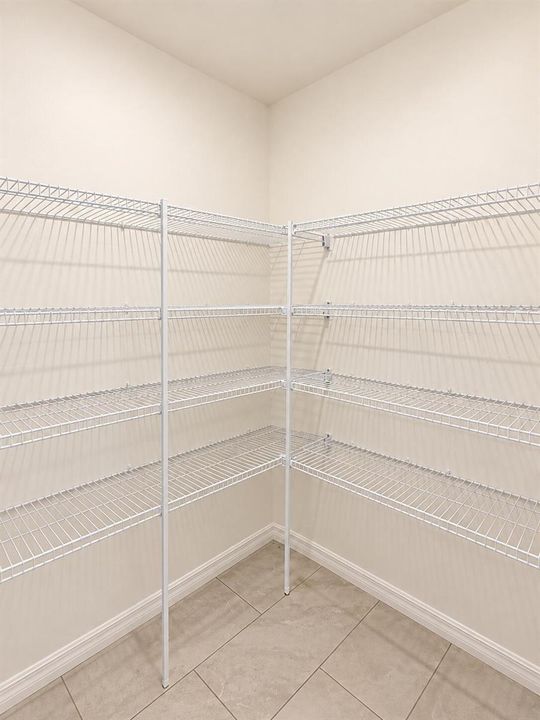 Bright Empty L-Shaped Pantry Shelving