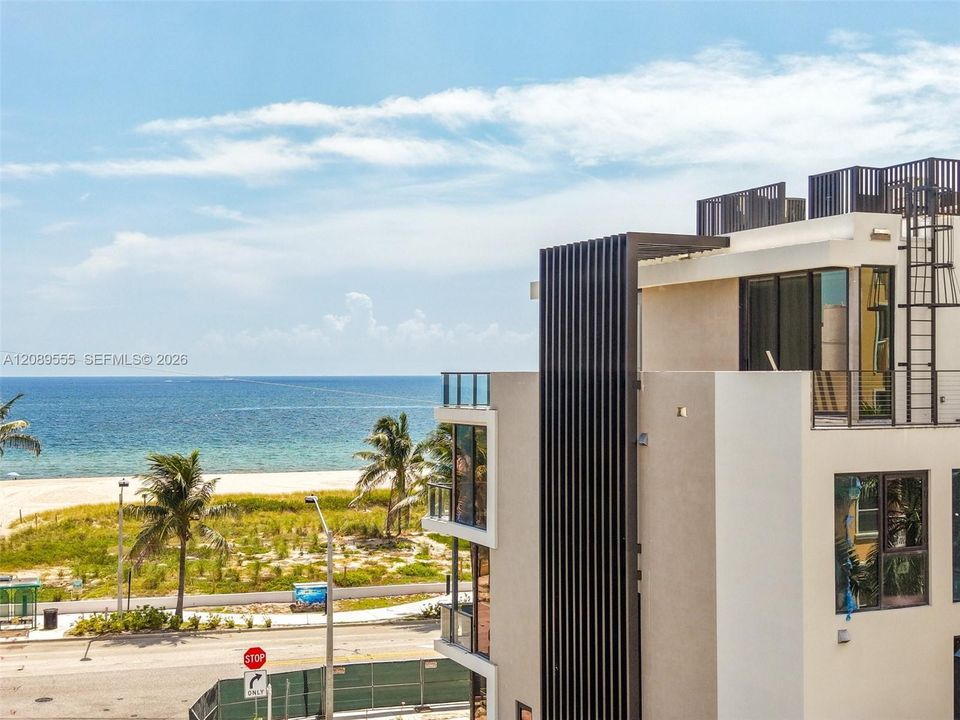 Facade detail, ocean beyond.