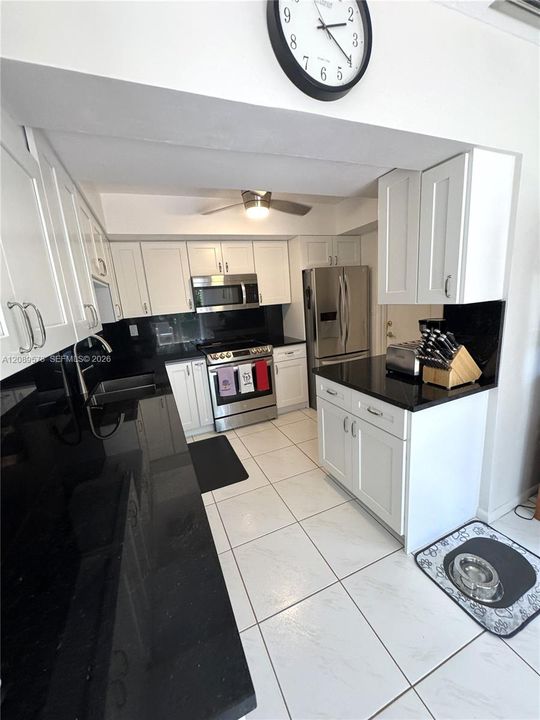 New kitchen with black granite counter tops, plus top of the line appliances - LG. Custom cabinets. Side door to garage.