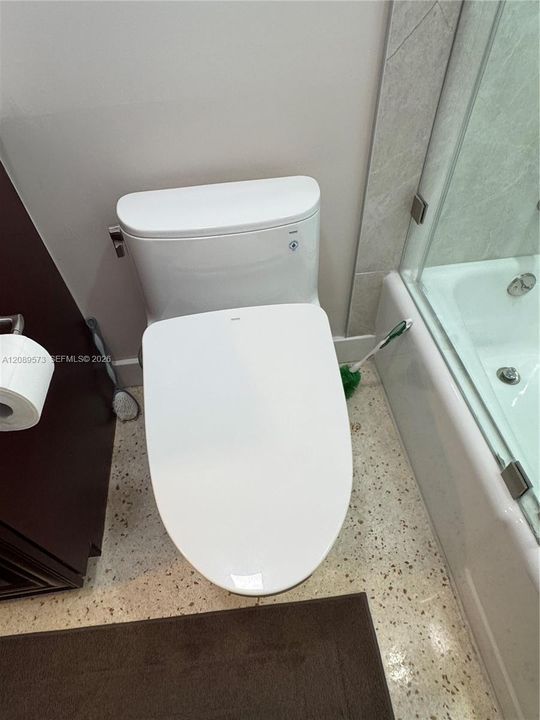 2nd Bathroom, custom shelving, marble top on vanity, beautiful tub/shower area with top of the line plumbing fixtures, plus Toto toilet.