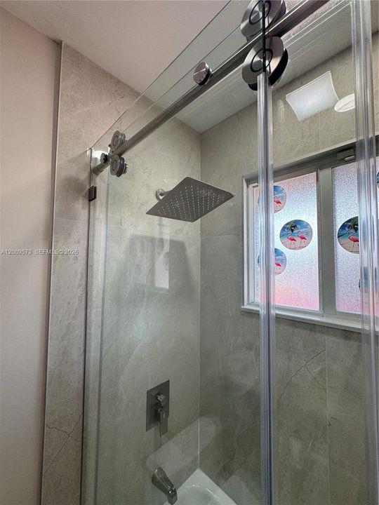 2nd Bathroom, custom shelving, marble top on vanity, beautiful tub/shower area with top of the line plumbing fixtures.